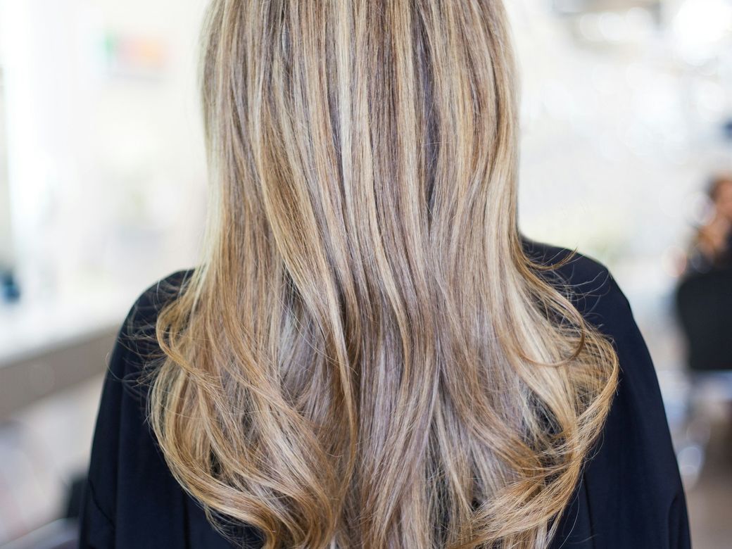 Long hair with full blonde highlights, seen from behind