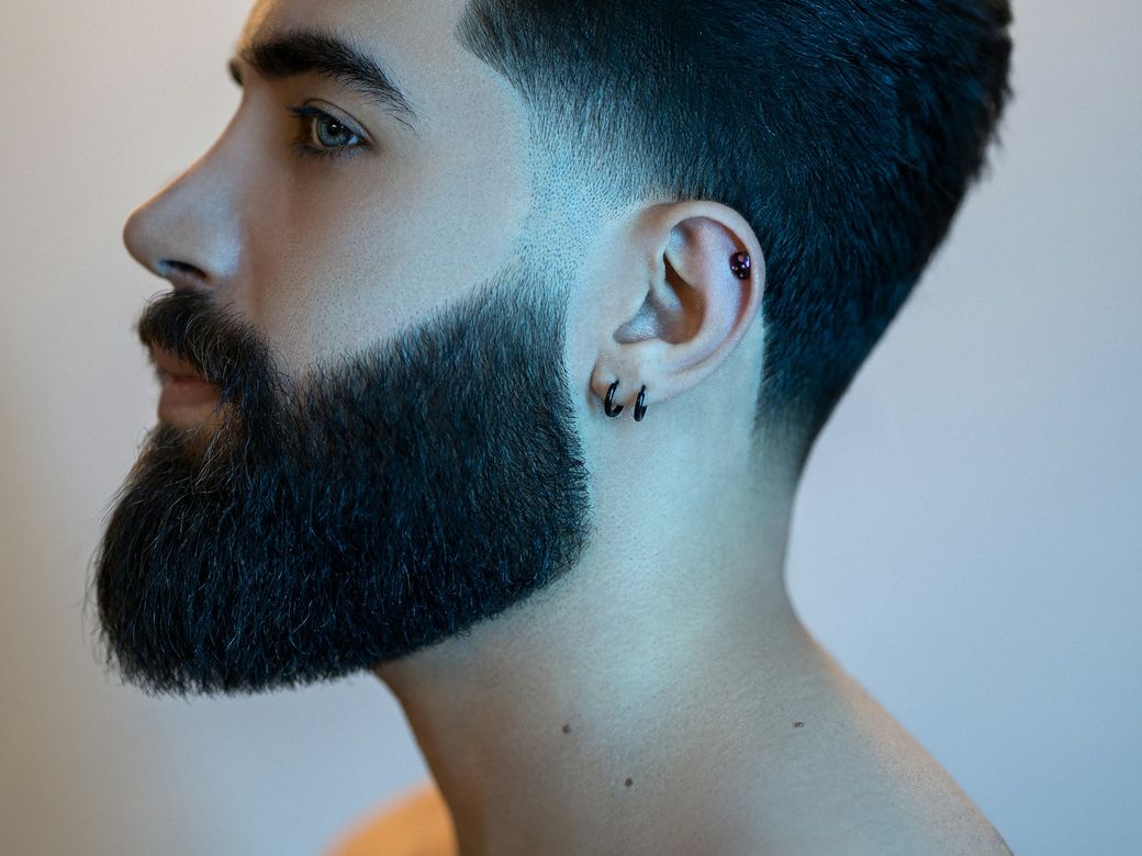 Men's haircut with a clean skin fade, side view